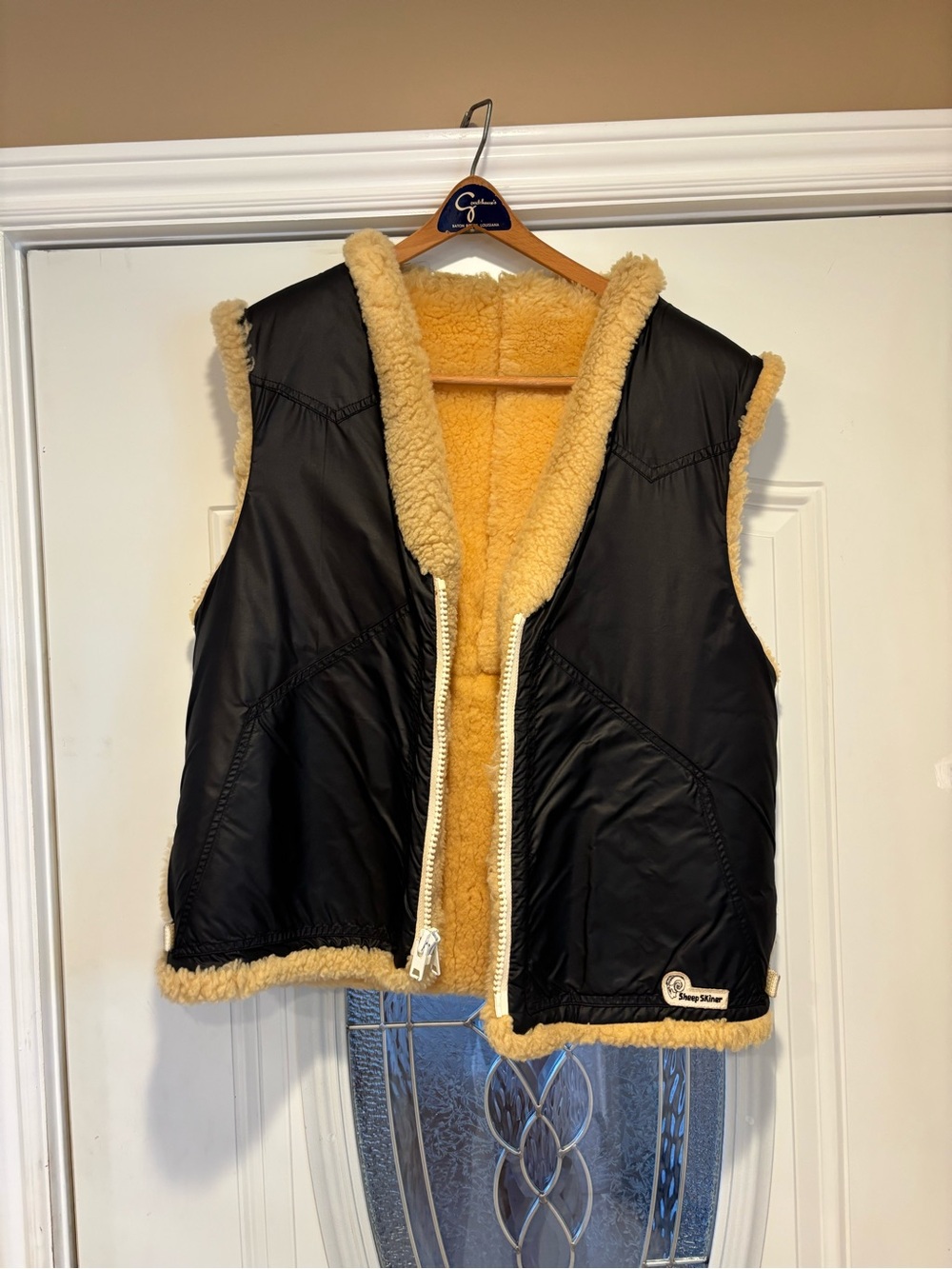 This is a vintage Sheep Skiner black nylon vest featuring a plush yellow fleece